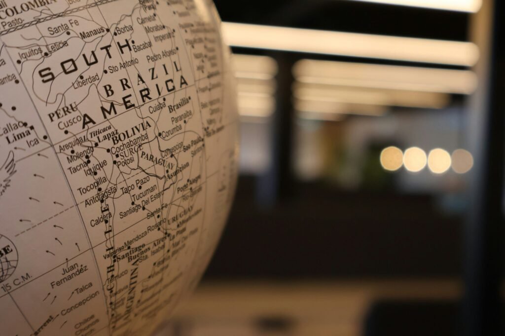 A close up of a globe with a building in the background A close up of a globe with a building in the background