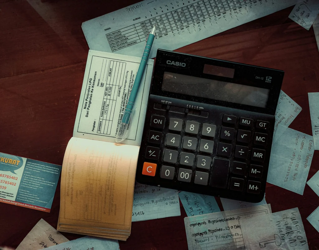 a calculator sitting on top of a wooden table a calculator sitting on top of a wooden table