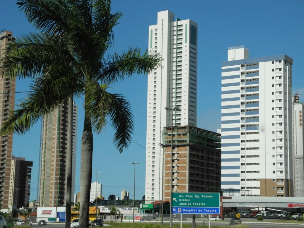 white high rise buildings near green palm trees during daytime white high rise buildings near green palm trees during daytime